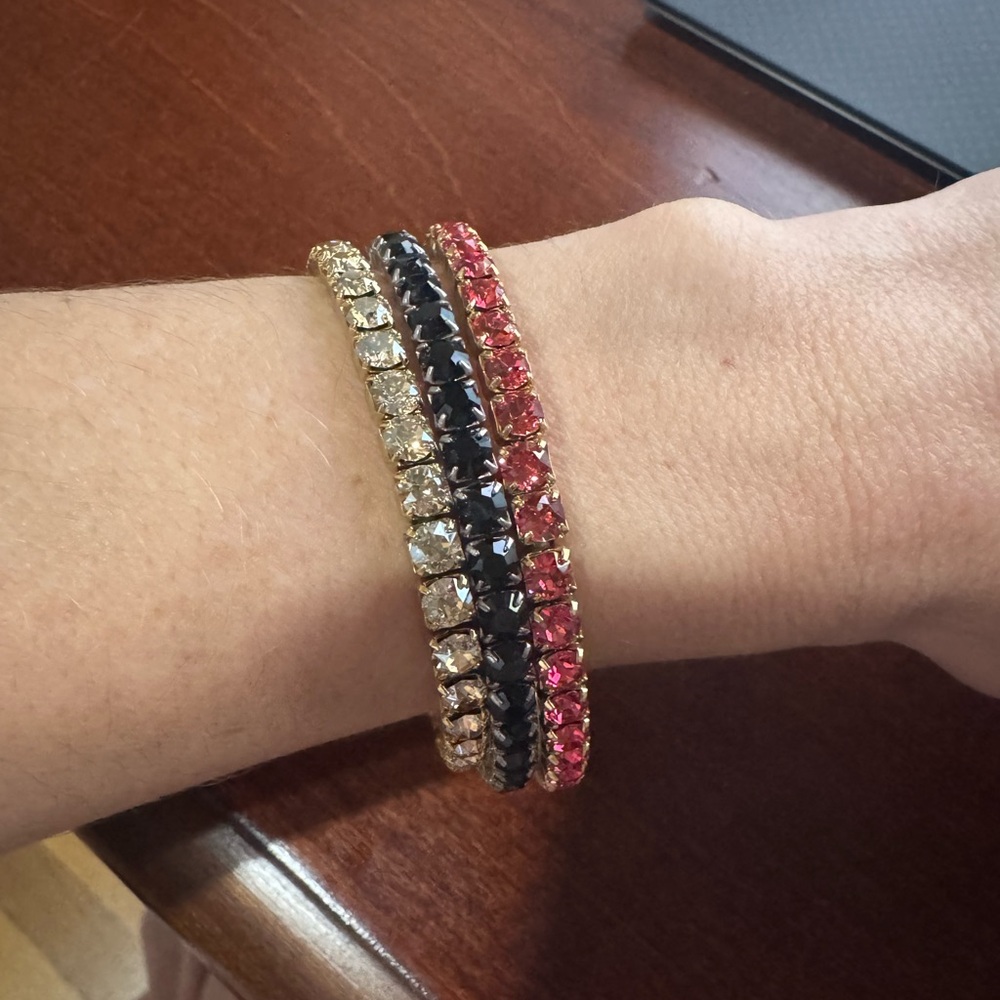 Set of 3 crystal Swarovski bracelets; gold, pink and black.